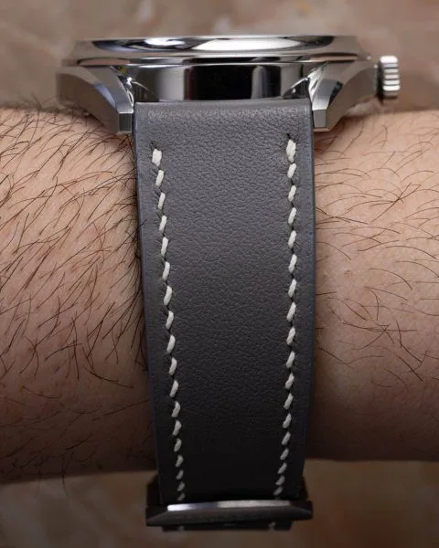 Divine Craft watch with gray leather strap and light green dial.