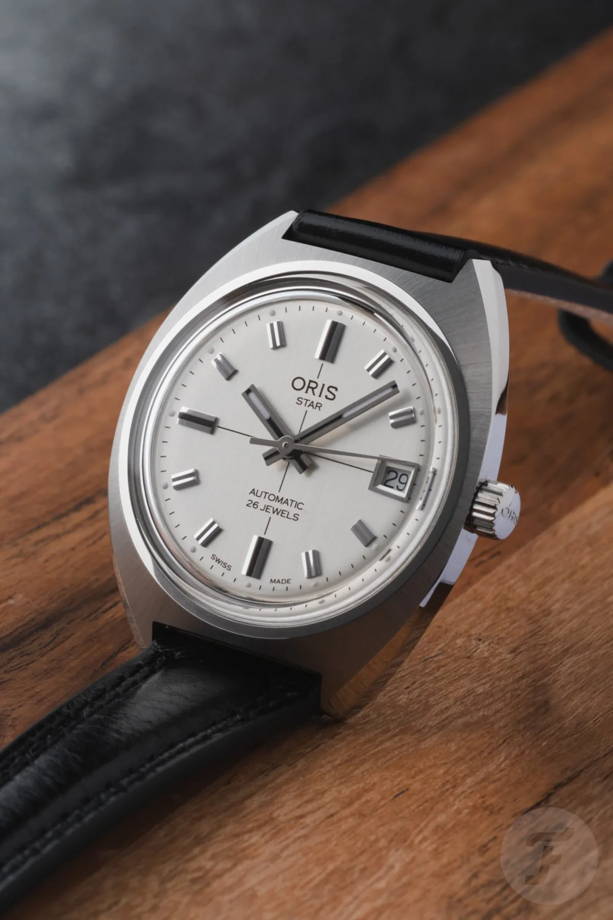 Oris Star with screw-down case back and crest engraving.